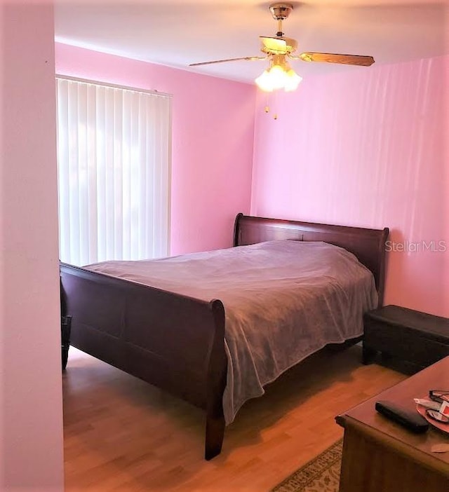 bedroom featuring ceiling fan and hardwood / wood-style flooring