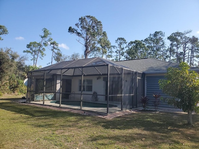 back of property featuring a lawn and a lanai