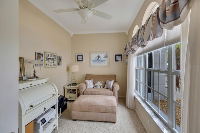 living area with ceiling fan, light colored carpet, and ornamental molding