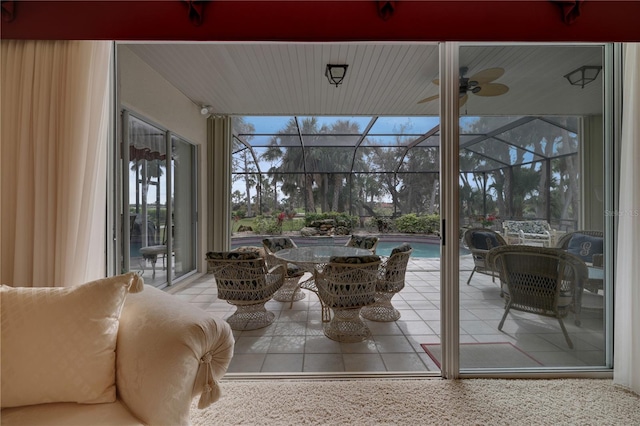 sunroom featuring ceiling fan