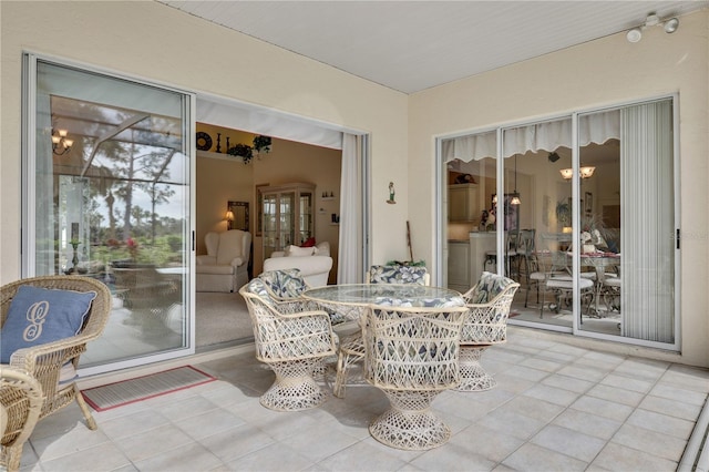 sunroom / solarium with an inviting chandelier