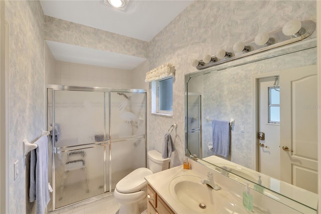 bathroom with walk in shower, vanity, and toilet