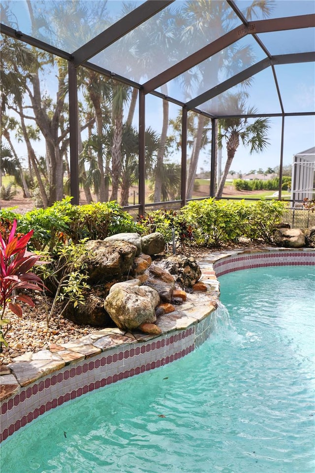 view of pool featuring pool water feature and a lanai