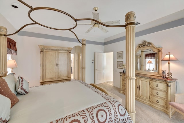 bedroom with ornate columns and light carpet