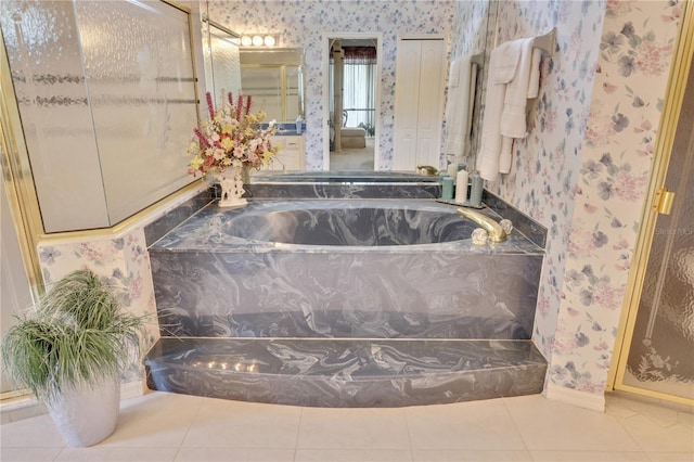 bathroom featuring tile patterned floors and a bath