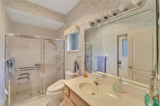 bathroom featuring tile patterned floors, vanity, toilet, and an enclosed shower