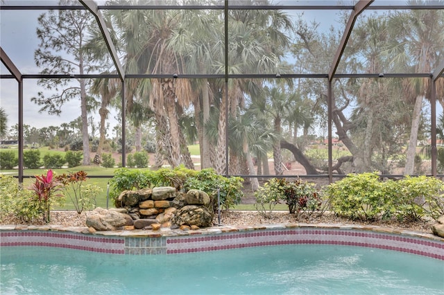 view of swimming pool featuring a lanai