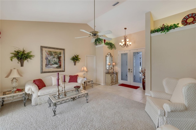 carpeted living room featuring french doors, ceiling fan with notable chandelier, and high vaulted ceiling