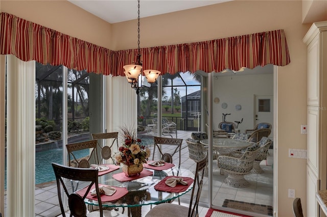 dining space featuring a chandelier and tile patterned floors