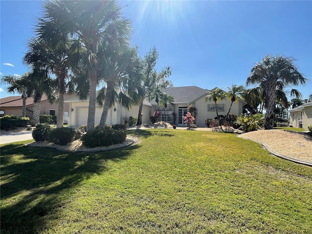 view of front facade featuring a front yard and a garage