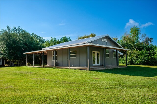 back of house with a lawn