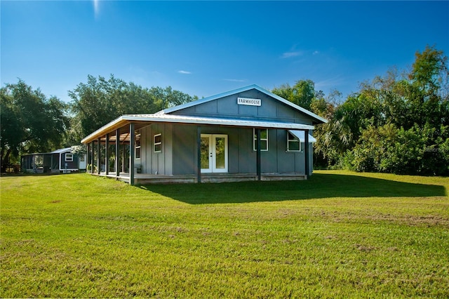 rear view of house featuring a lawn