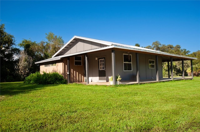 rear view of property featuring a yard