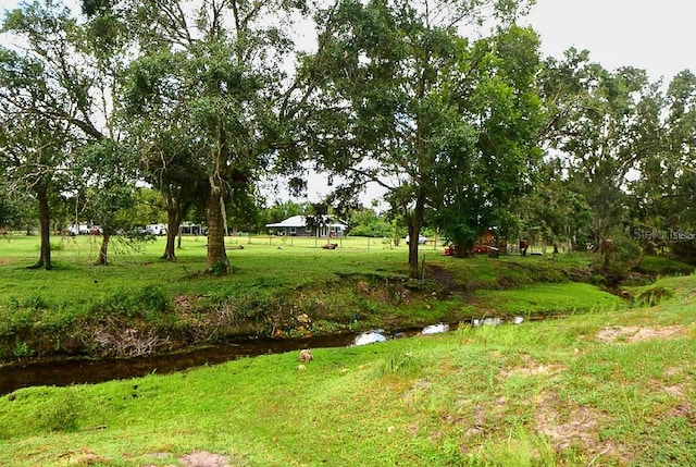 view of yard featuring a water view and a gazebo