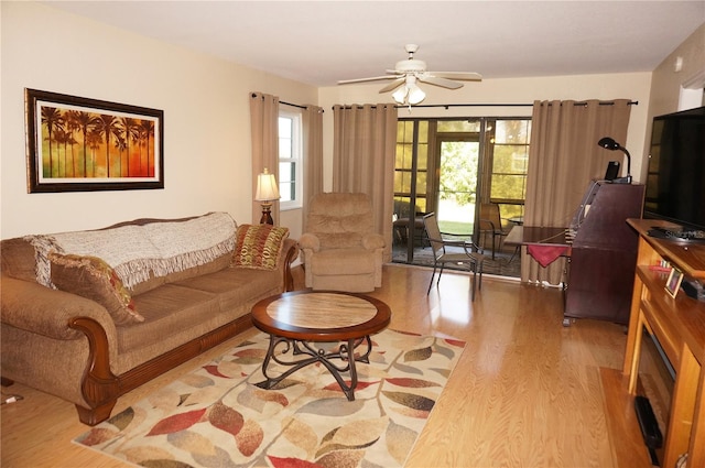 living room featuring light hardwood / wood-style floors and ceiling fan