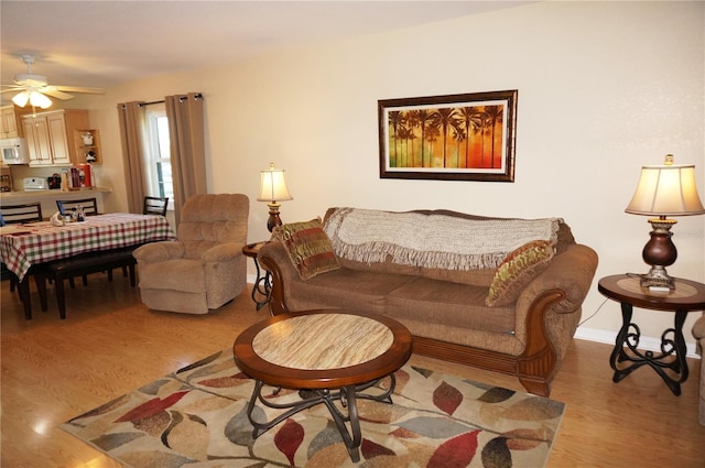 living room featuring light hardwood / wood-style floors and ceiling fan