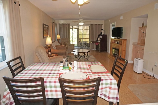 dining space featuring ceiling fan and light wood-type flooring