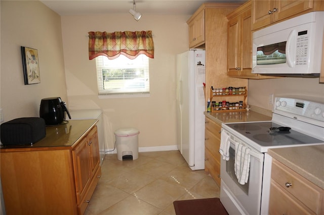 kitchen with white appliances and light tile floors