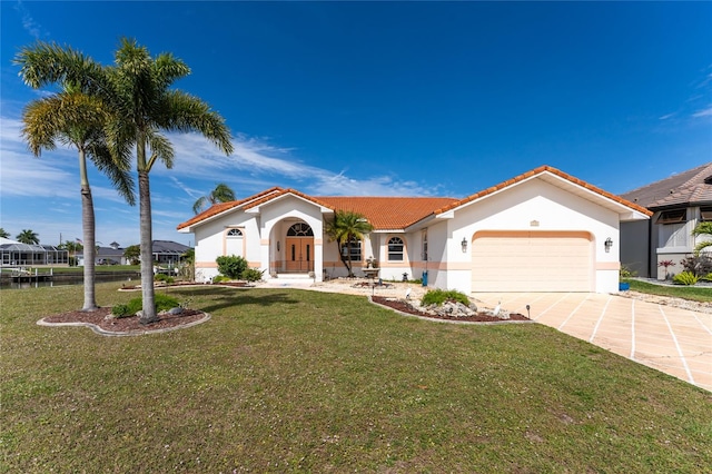 mediterranean / spanish house with a front yard and a garage