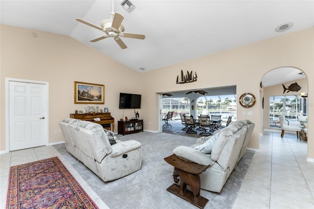 living room featuring ceiling fan, light tile patterned flooring, and vaulted ceiling