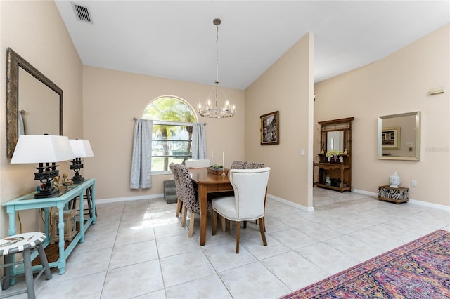 dining area featuring lofted ceiling, light tile patterned floors, and an inviting chandelier