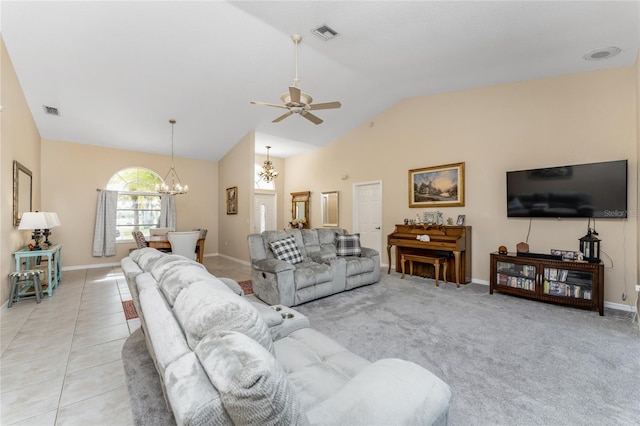 living room with ceiling fan with notable chandelier, light tile patterned flooring, and lofted ceiling