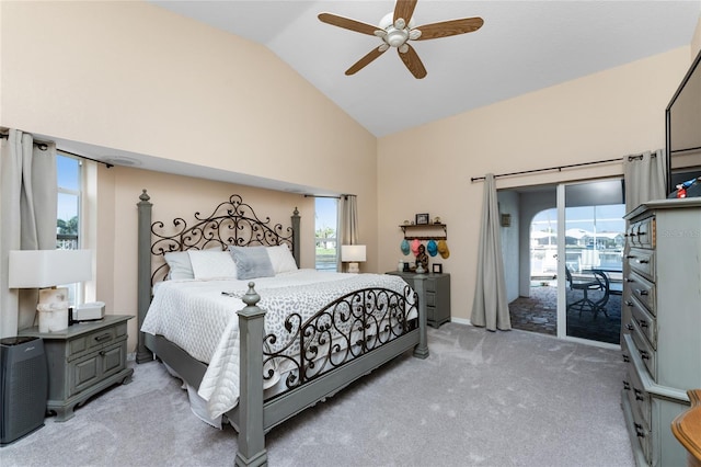 bedroom with ceiling fan, access to exterior, lofted ceiling, and multiple windows