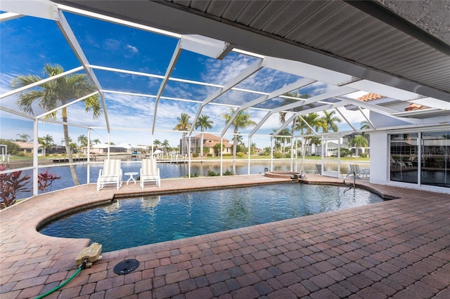 view of swimming pool with a lanai, a water view, a patio, and a hot tub