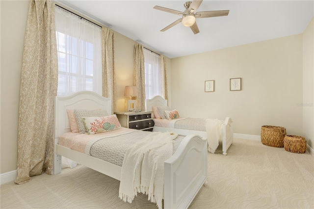 bedroom with light carpet and ceiling fan