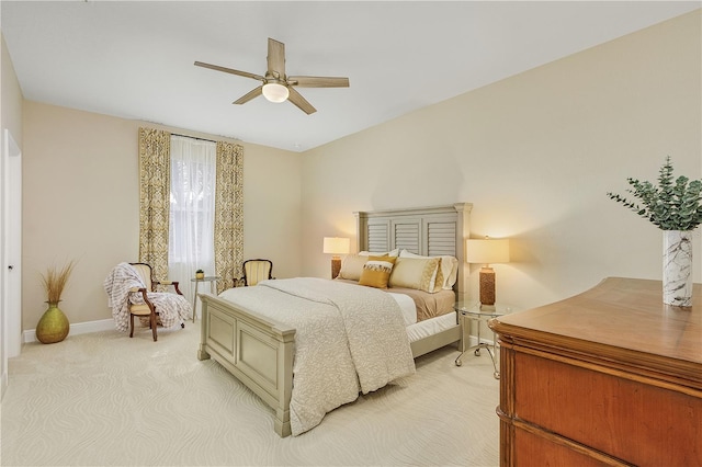 bedroom featuring light carpet and ceiling fan