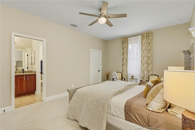 carpeted bedroom with connected bathroom, ceiling fan, and sink