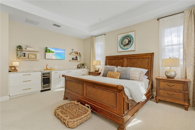 carpeted bedroom with beverage cooler