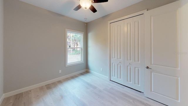 unfurnished bedroom featuring a closet, ceiling fan, and light wood-type flooring