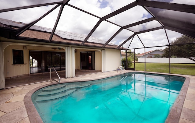 view of swimming pool with a lanai, a patio, and a yard