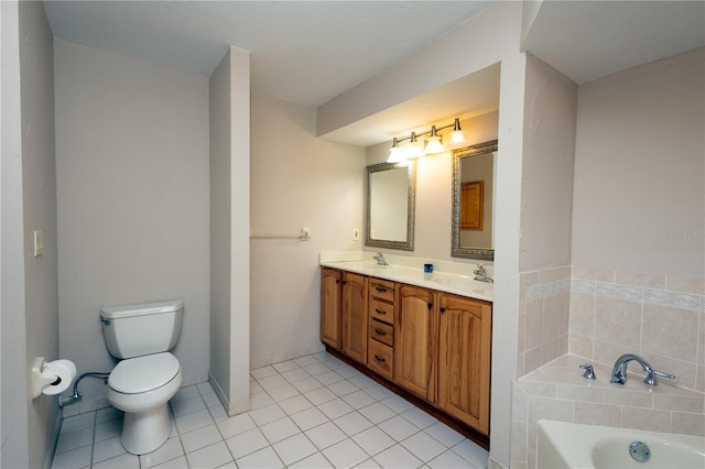 bathroom with vanity, tile patterned flooring, toilet, and a tub