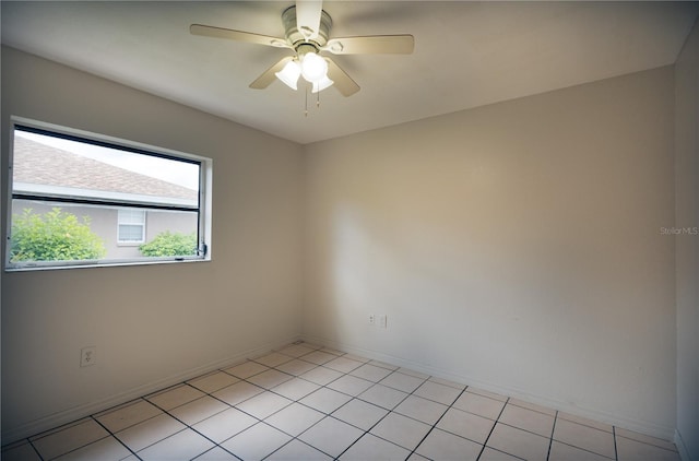 tiled empty room featuring ceiling fan