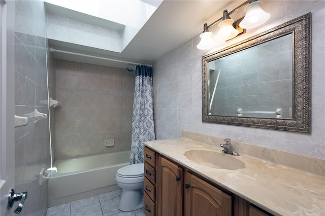 full bathroom with tile walls, vanity, shower / bath combination with curtain, toilet, and tile patterned floors