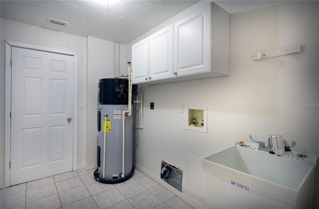 clothes washing area featuring hookup for an electric dryer, a textured ceiling, sink, light tile patterned floors, and water heater