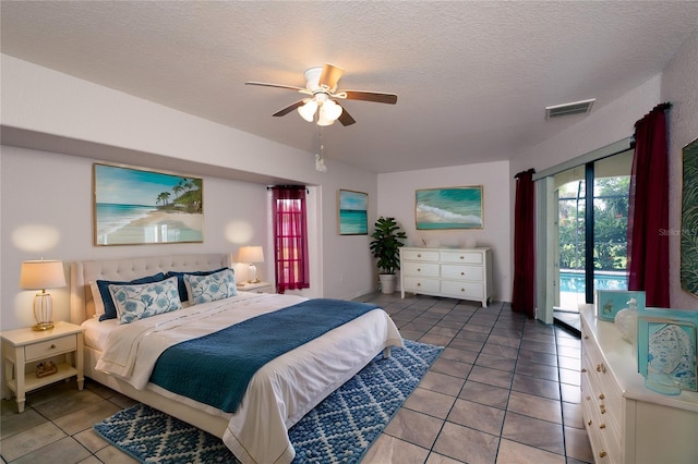 tiled bedroom with access to outside, a textured ceiling, and ceiling fan