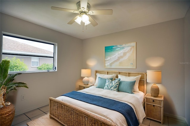 tiled bedroom featuring ceiling fan