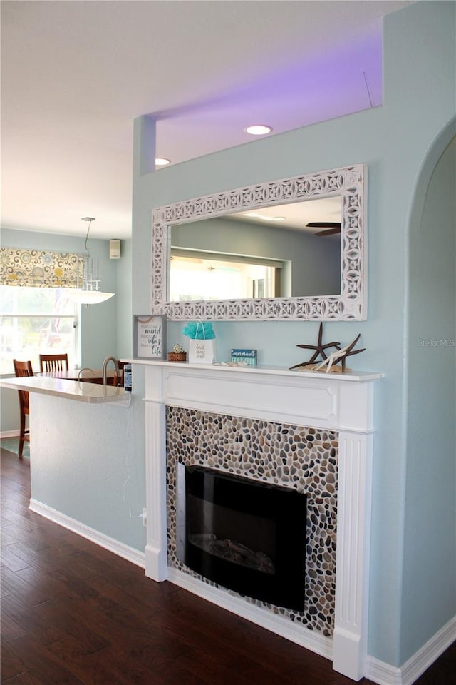 room details featuring hardwood / wood-style floors and a tiled fireplace