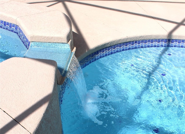 view of swimming pool featuring pool water feature