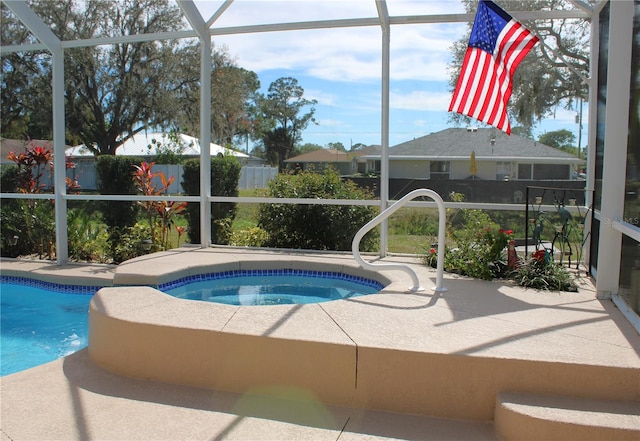 view of swimming pool featuring a patio, a lanai, and an in ground hot tub