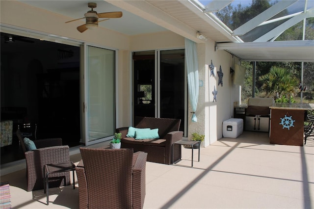 view of patio with a lanai, an outdoor hangout area, grilling area, and ceiling fan