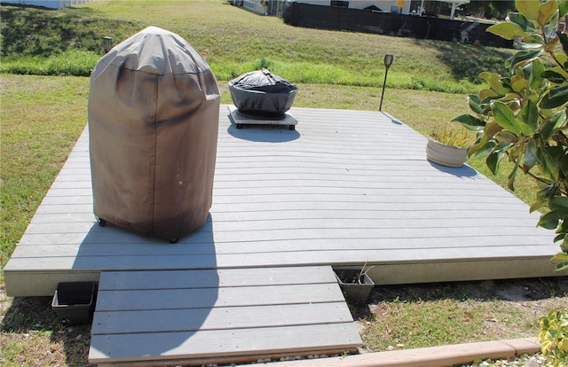 deck featuring a yard and a grill