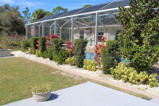 view of yard featuring a patio and a lanai