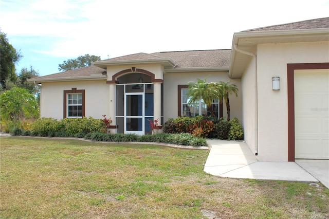 property entrance with a yard and a garage