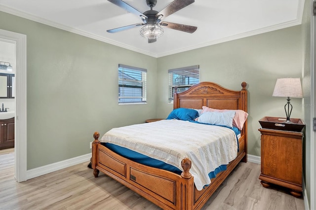 bedroom with light wood-type flooring, ensuite bathroom, ceiling fan, crown molding, and sink