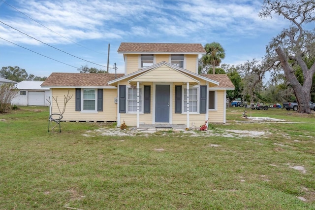 view of front of house with covered porch and a front yard