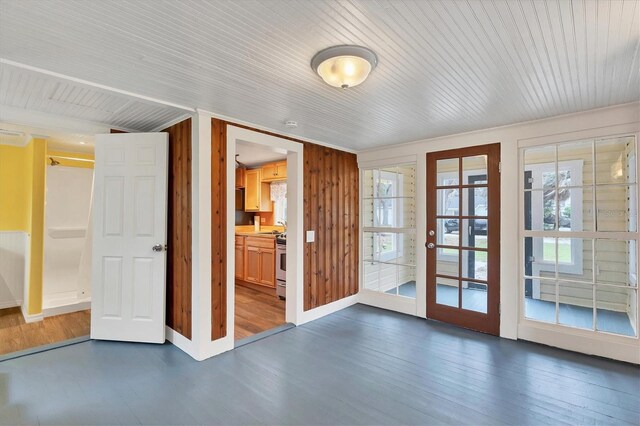 doorway with wood walls, french doors, and dark hardwood / wood-style floors